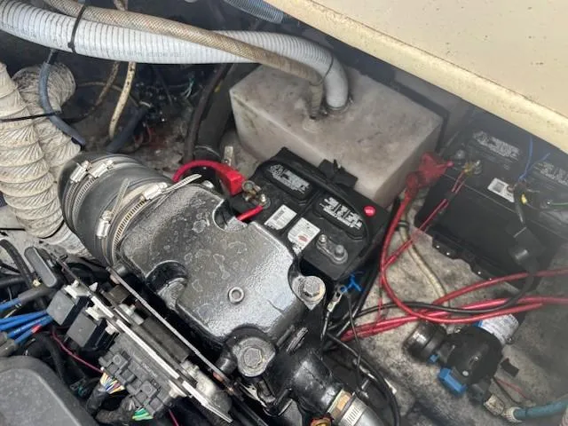 Slide: The Image of Engine compartment of a 2006 Rinker 232 Captiva Bowrider with visible battery and wiring. - 17