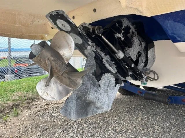 Slide: The Image of 2006 Rinker 232 Captiva Bowrider propeller and stern drive, showing wear and corrosion. - 23
