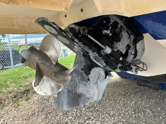 Slide: The Image of Damaged propeller of 2006 Rinker 232 Captiva Bowrider on gravel surface. - 24