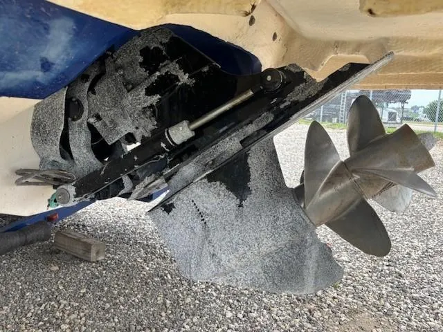 Slide: The Image of Propeller and stern drive of a 2006 Rinker 232 Captiva Bowrider on gravel surface. - 25