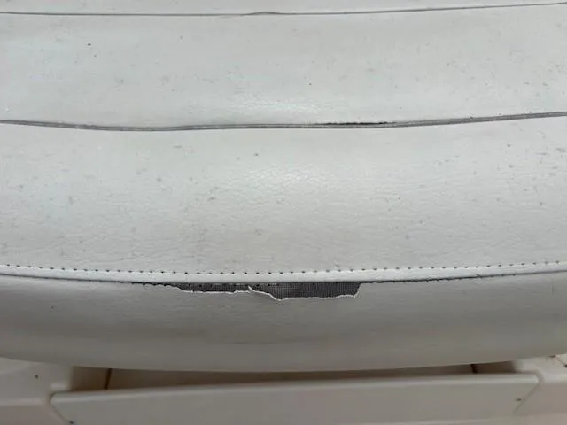 Slide: The Image of 2006 Rinker 232 Captiva Bowrider seat with visible wear and tear. - 26