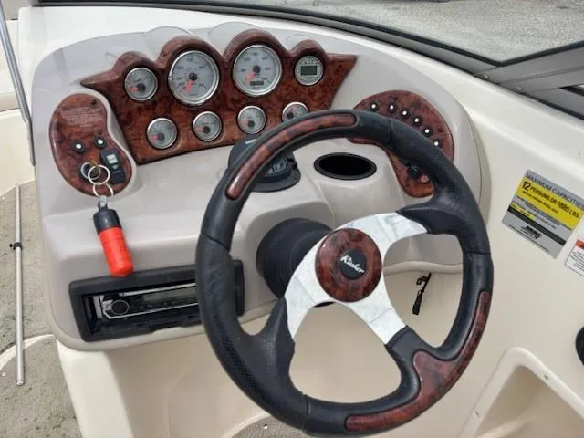 Slide: The Image of Dashboard of a 2006 Rinker 232 Captiva Bowrider with steering wheel and gauges. - 3