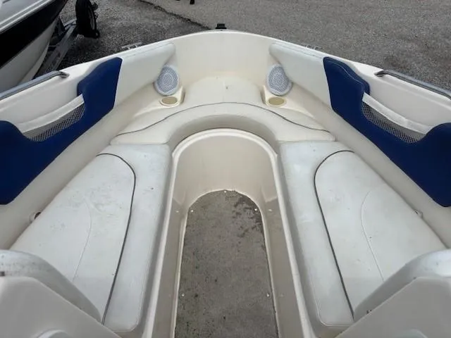 Slide: The Image of 2006 Rinker 232 Captiva Bowrider interior with white seating and blue accents. - 5