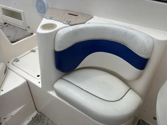 Slide: The Image of 2006 Rinker 232 Captiva Bowrider interior seating with blue and white upholstery. - 6