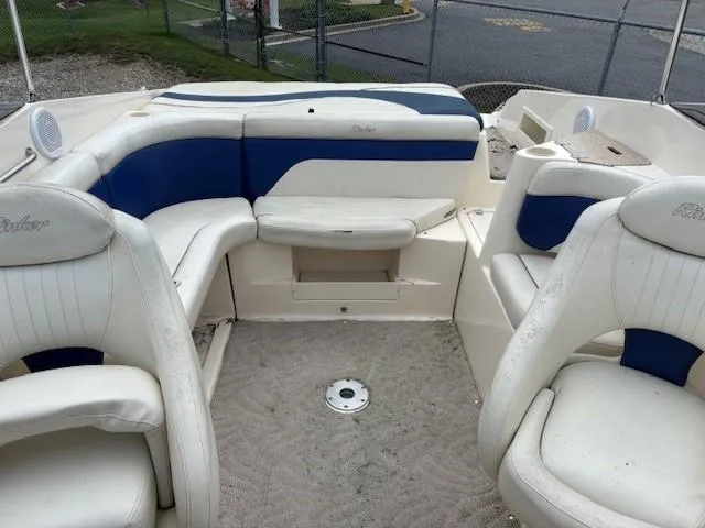 Slide: The Image of 2006 Rinker 232 Captiva Bowrider interior with white and blue seating. - 7