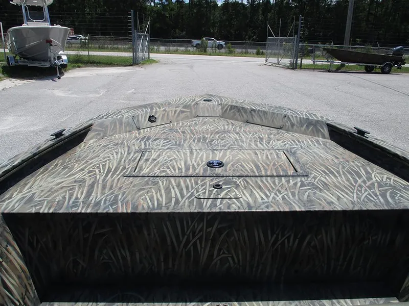 Slide: The Image of 2026 Tracker Grizzly 1648 SC boat with camouflage pattern, parked outdoors. - 10