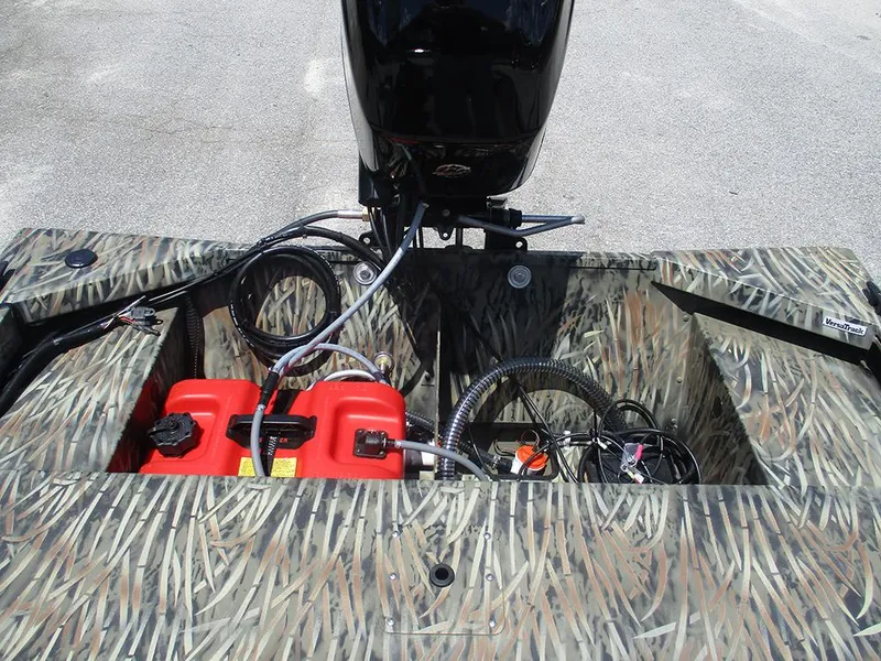 Slide: The Image of 2026 Tracker Grizzly 1648 SC boat with camo design and visible engine components. - 17