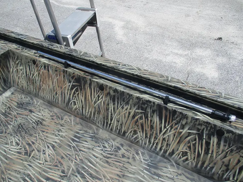 Slide: The Image of 2026 Tracker Grizzly 1648 SC boat interior with camouflage design and mounted equipment. - 18