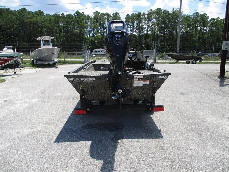 Slide: The Image of 2026 Tracker Grizzly 1648 SC boat on trailer, parked outdoors. - 8