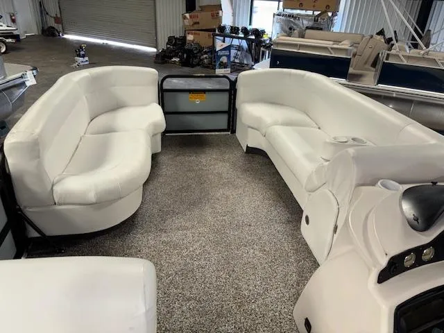 Slide: The Image of Interior of 2002 AquaPatio AP220R pontoon boat with white seating and carpeted floor. - 11