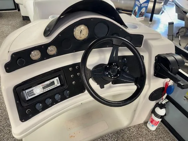 Slide: The Image of Steering console of a 2002 AquaPatio AP220R boat with gauges and controls. - 16