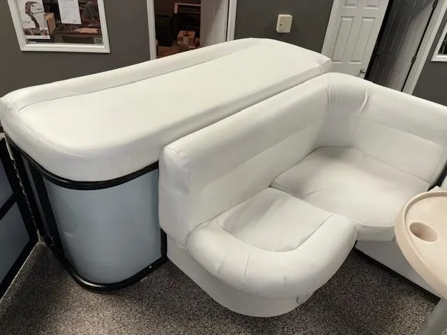 Slide: The Image of 2002 AquaPatio AP220R boat interior with white cushioned seating. - 18