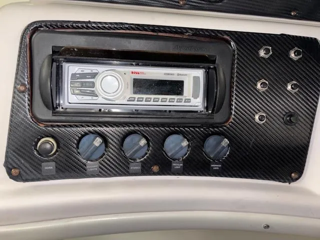 Slide: The Image of Control panel of 2002 AquaPatio AP220R with stereo system and switches. - 19