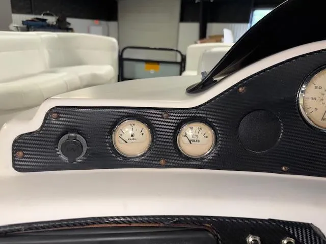 Slide: The Image of Dashboard of a 2002 AquaPatio AP220R boat with fuel and voltage gauges. - 20