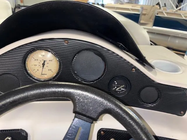 Slide: The Image of Dashboard of a 2002 AquaPatio AP220R boat with speedometer and steering wheel. - 21