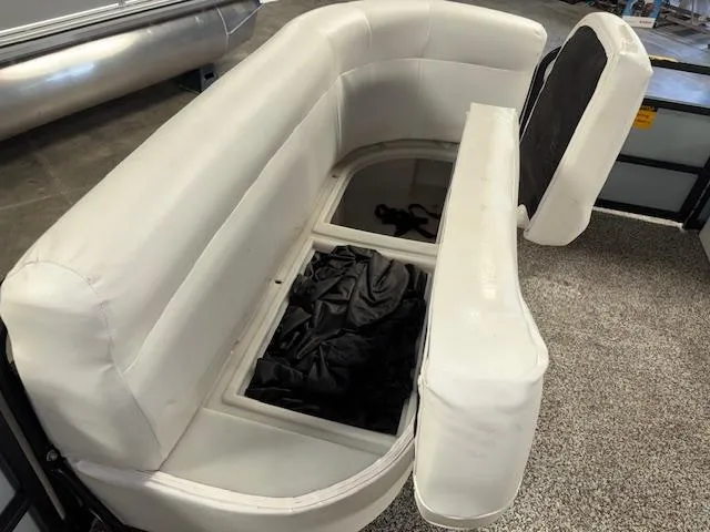 Slide: The Image of AquaPatio AP220R 2002 boat seat with storage compartment, featuring white upholstery. - 23