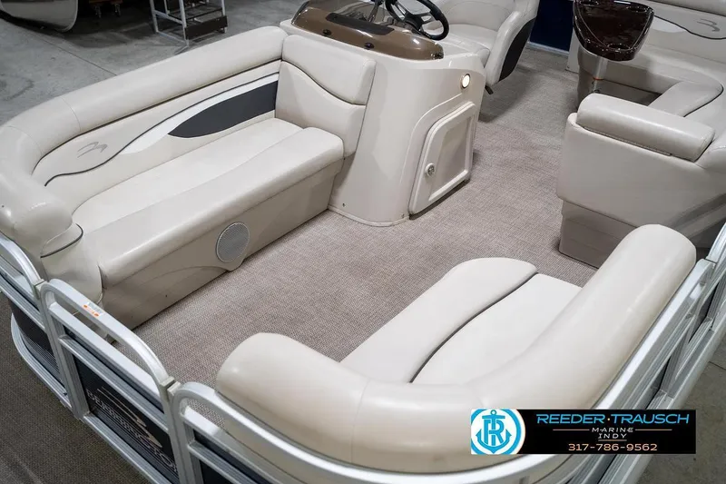 Slide: The Image of 2019 Bennington 18 SLV pontoon boat interior with beige seating and steering console. - 12