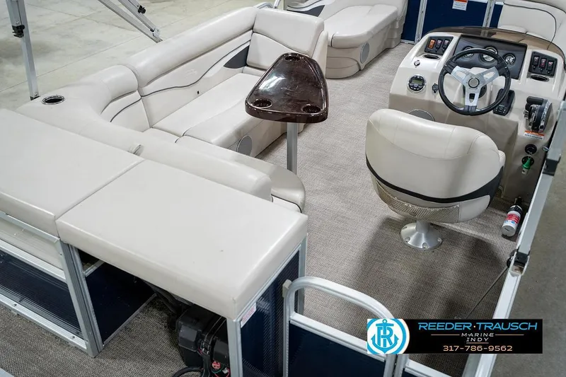 Slide: The Image of 2019 Bennington 18 SLV pontoon boat interior with beige seating and steering console. - 14