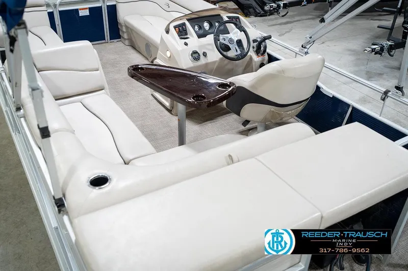 Slide: The Image of 2019 Bennington 18 SLV pontoon boat interior with beige seating and steering console. - 15