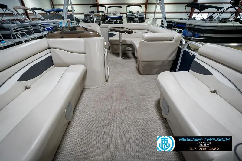 Slide: The Image of 2019 Bennington 18 SLV pontoon boat interior with beige seating in a showroom. - 16