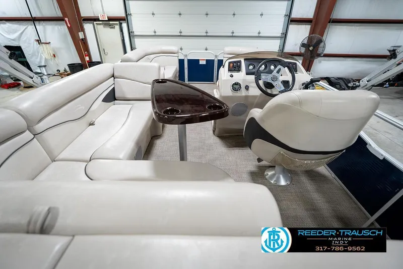 Slide: The Image of 2019 Bennington 18 SLV pontoon boat interior with plush seating and modern helm. - 18