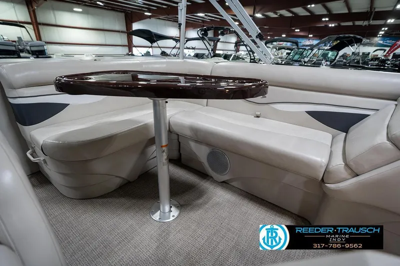 Slide: The Image of 2019 Bennington 18 SLV pontoon boat interior with seating and table in showroom. - 23