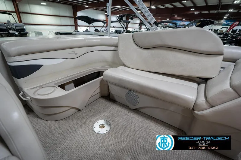 Slide: The Image of 2019 Bennington 18 SLV boat interior with beige seating and cup holder. - 26