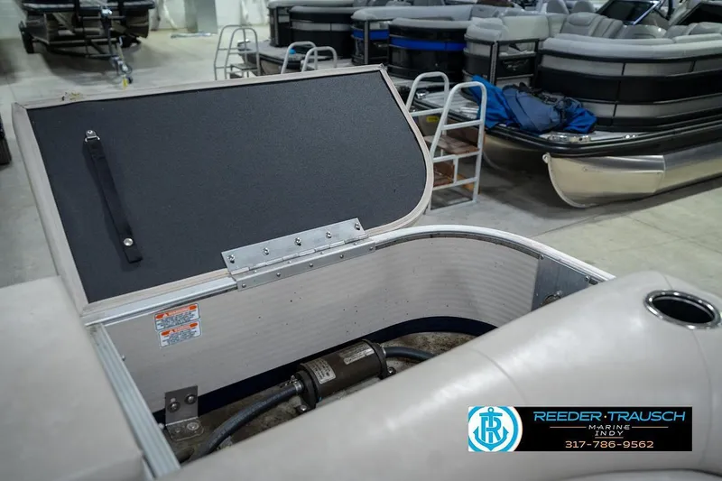 Slide: The Image of 2019 Bennington 18 SLV pontoon boat storage compartment open in showroom. - 28
