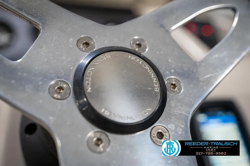 Slide: The Image of Close-up of a 2019 Bennington 18 SLV steering wheel with logo. - 31