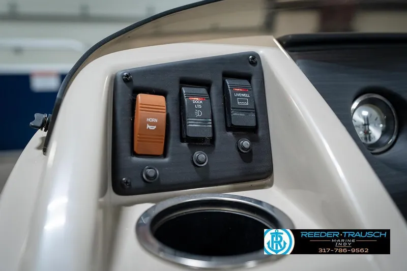 Slide: The Image of Control panel of 2019 Bennington 18 SLV boat with switches and cup holder. - 33