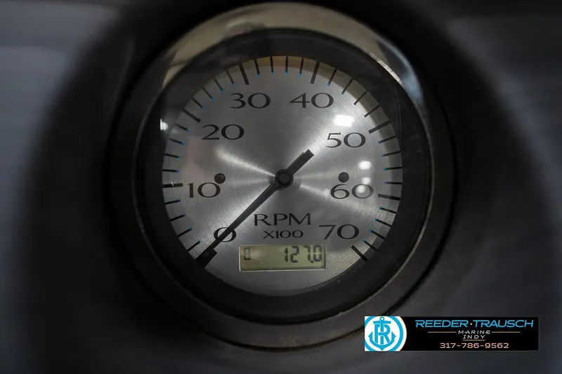Slide: The Image of Close-up of a 2019 Bennington 18 SLV RPM gauge displaying 1210 RPM. - 35