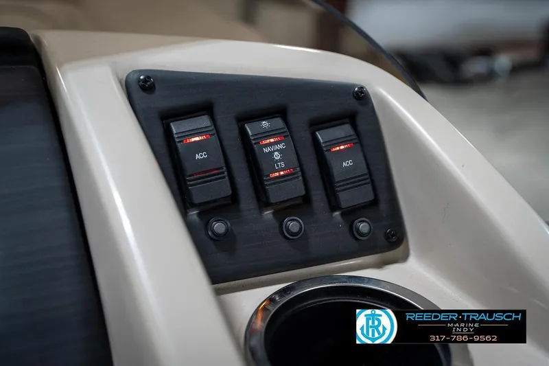 Slide: The Image of Control panel of 2019 Bennington 18 SLV boat with switches and cup holder. - 36