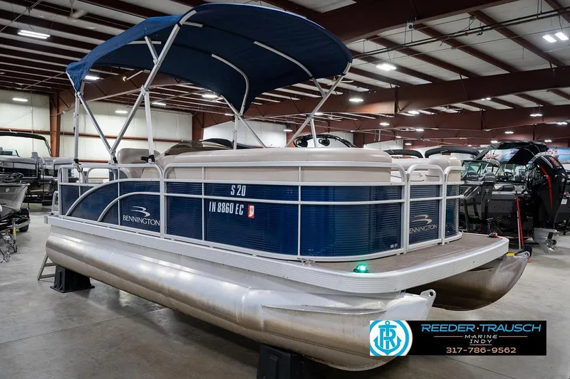 Slide: The Image of 2019 Bennington 18 SLV pontoon boat in showroom with blue canopy. - 6