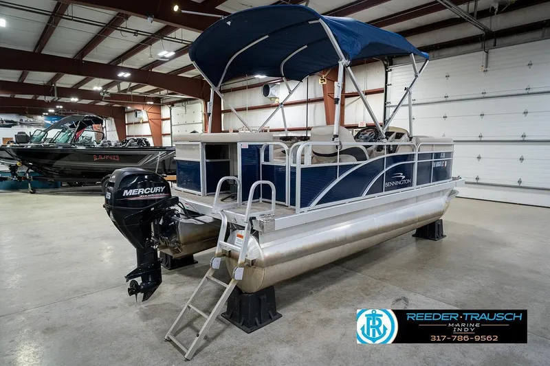 Slide: The Image of 2019 Bennington 18 SLV pontoon boat with Mercury outboard in indoor showroom. - 8