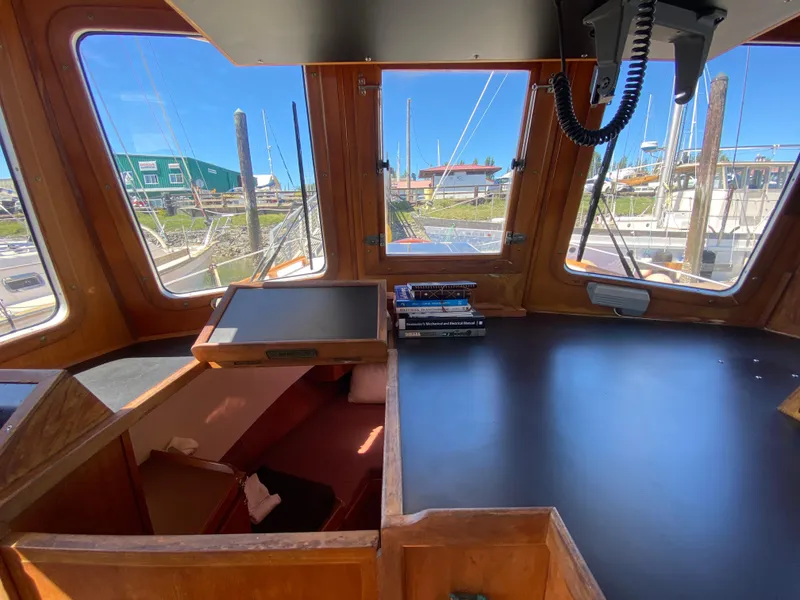Slide: The Image of 1986 Transpacific Marine Eagle boat interior with navigation station and marina view. - 19