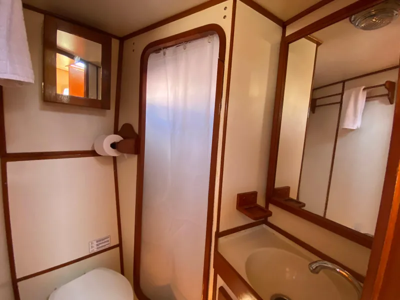 Slide: The Image of 1986 Transpacific Marine Eagle bathroom with shower, sink, and mirror. - 21
