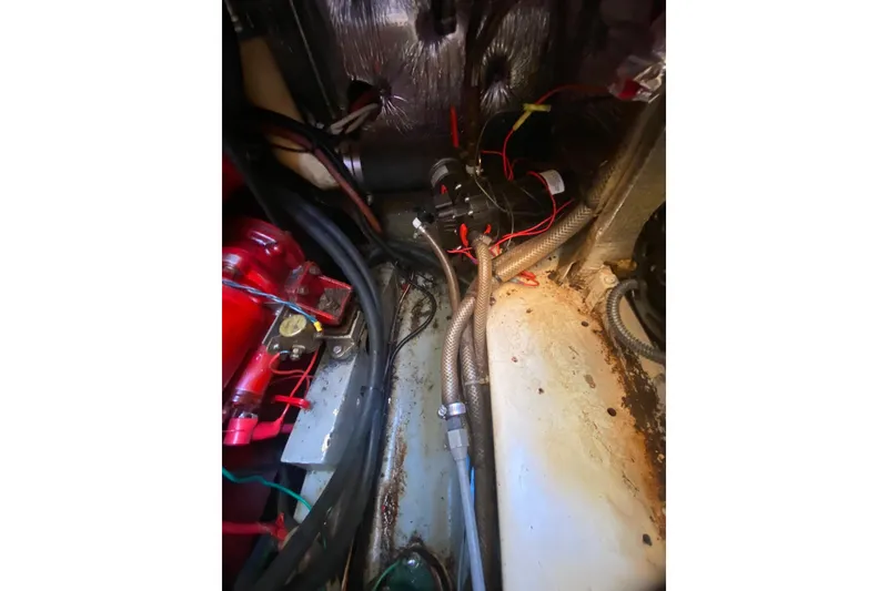Slide: The Image of 1986 Transpacific Marine Eagle engine compartment with wiring and hoses. - 28