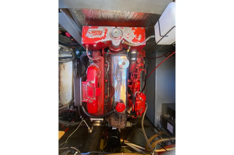 Slide: The Image of 1986 Transpacific Marine Eagle engine, red and metallic components, in a boat's engine compartment. - 30