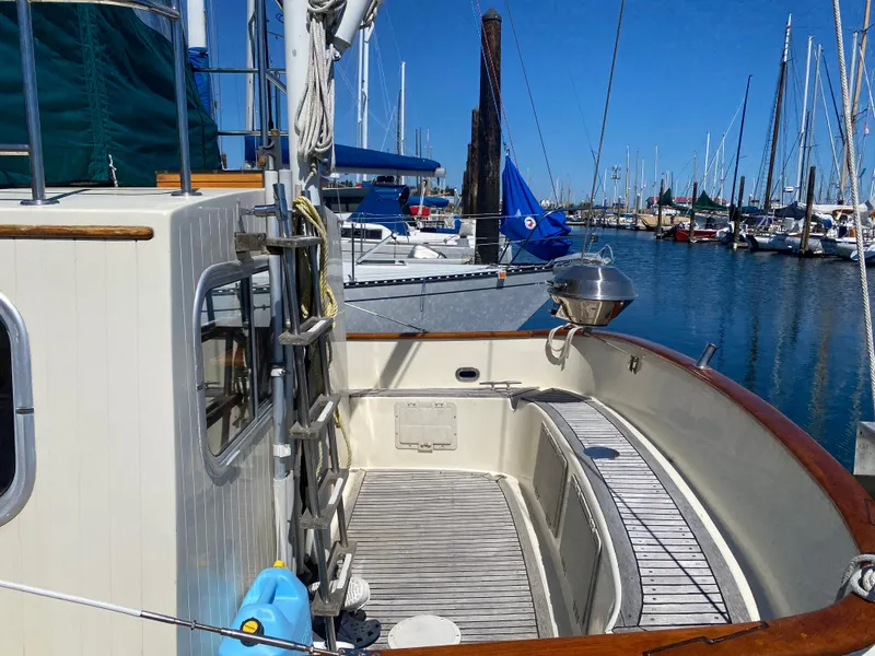 Slide: The Image of 1986 Transpacific Marine Eagle boat docked at marina, featuring wooden deck and nautical equipment. - 5
