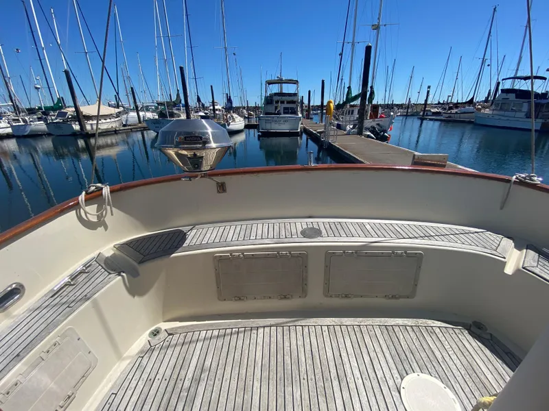 Slide: The Image of 1986 Transpacific Marine Eagle boat docked in a marina, surrounded by sailboats. - 7