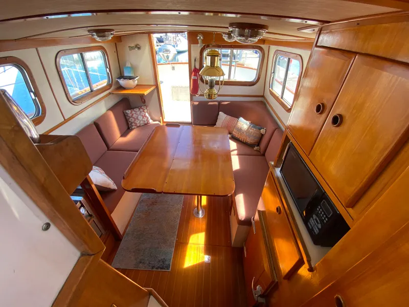 Slide: The Image of 1986 Transpacific Marine Eagle interior with wooden furnishings and cozy seating area. - 9
