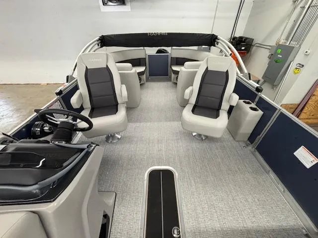 Slide: The Image of 2025 Harris Cruiser 230 CWDH interior with modern seating and steering wheel. - 11