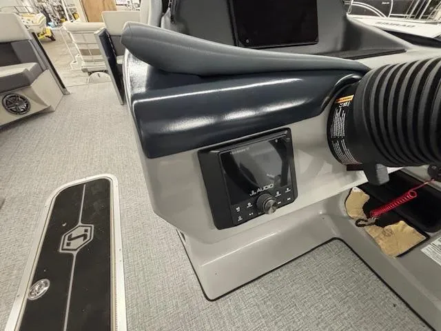 Slide: The Image of 2025 Harris Cruiser 230 CWDH boat interior with JL Audio system and modern dashboard. - 4