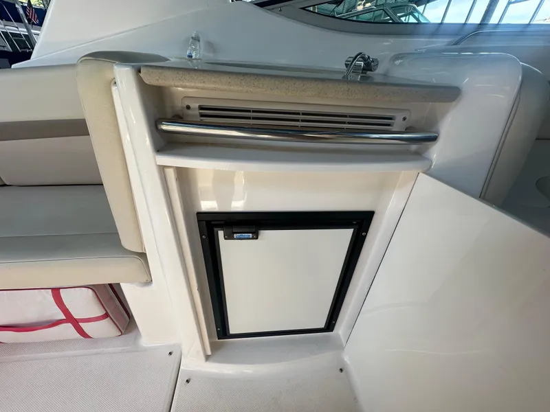 Slide: The Image of 2004 Chaparral Signature 330 boat interior with mini fridge and sink. - 12