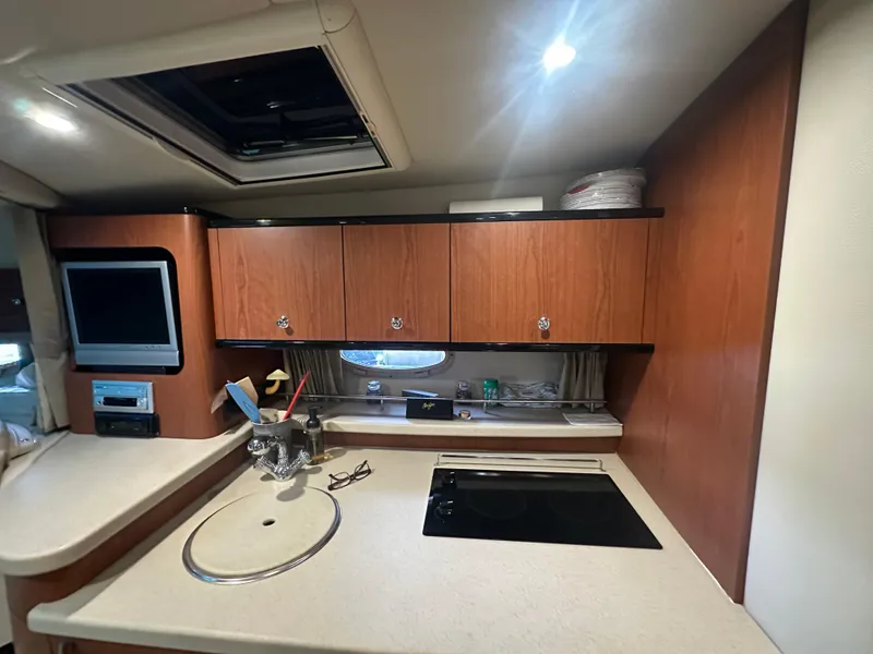 Slide: The Image of 2004 Chaparral Signature 330 interior kitchen with wooden cabinets and modern appliances. - 17