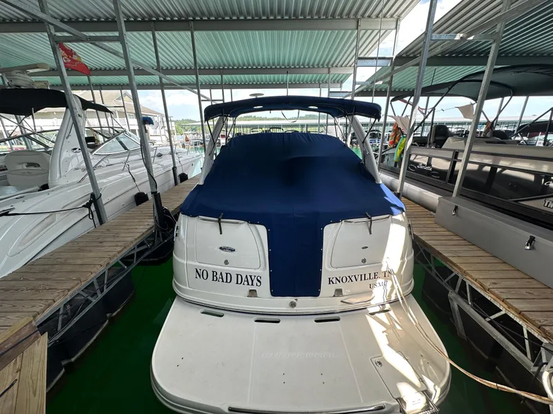 Slide: The Image of 2004 Chaparral Signature 330 boat docked, covered with blue tarp, labeled "No Bad Days." - 2