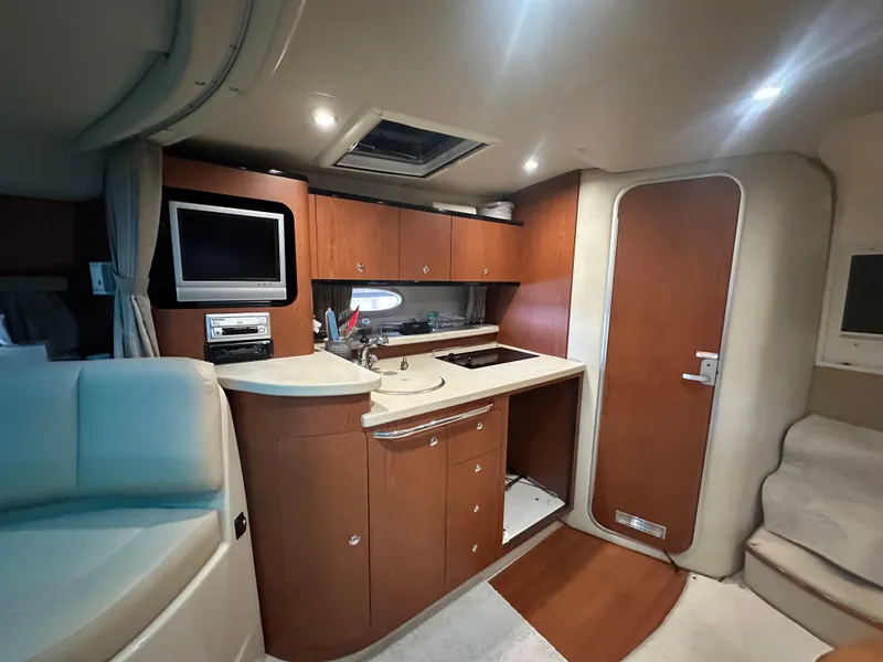 Slide: The Image of Interior of 2004 Chaparral Signature 330 yacht with kitchenette and seating area. - 20