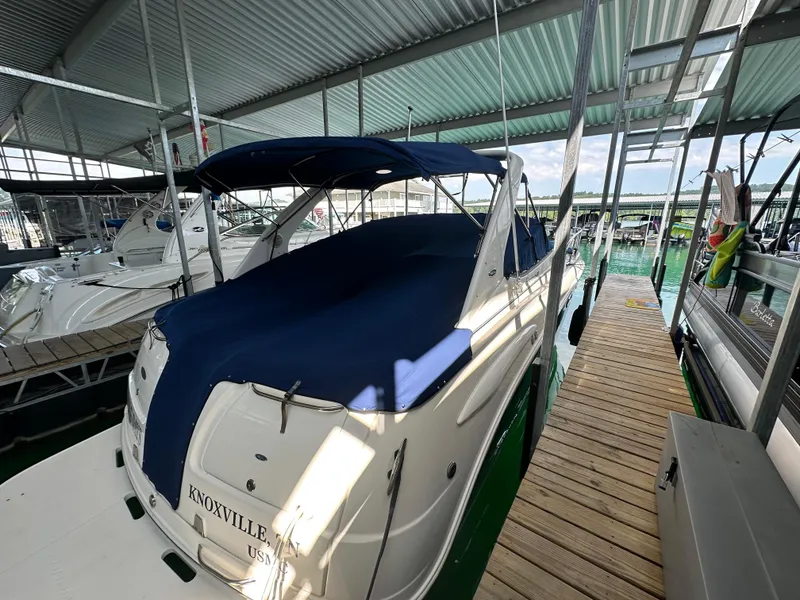 Slide: The Image of 2004 Chaparral Signature 330 boat docked with blue cover in marina. - 3
