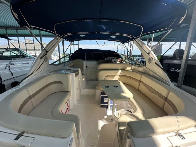 Slide: The Image of 2004 Chaparral Signature 330 boat interior with beige seating and blue canopy. - 5