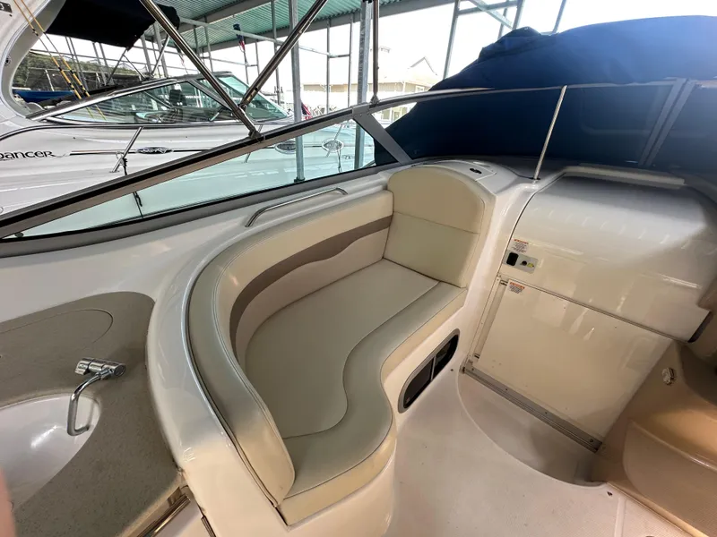 Slide: The Image of 2004 Chaparral Signature 330 interior with beige seating and compact sink area. - 8